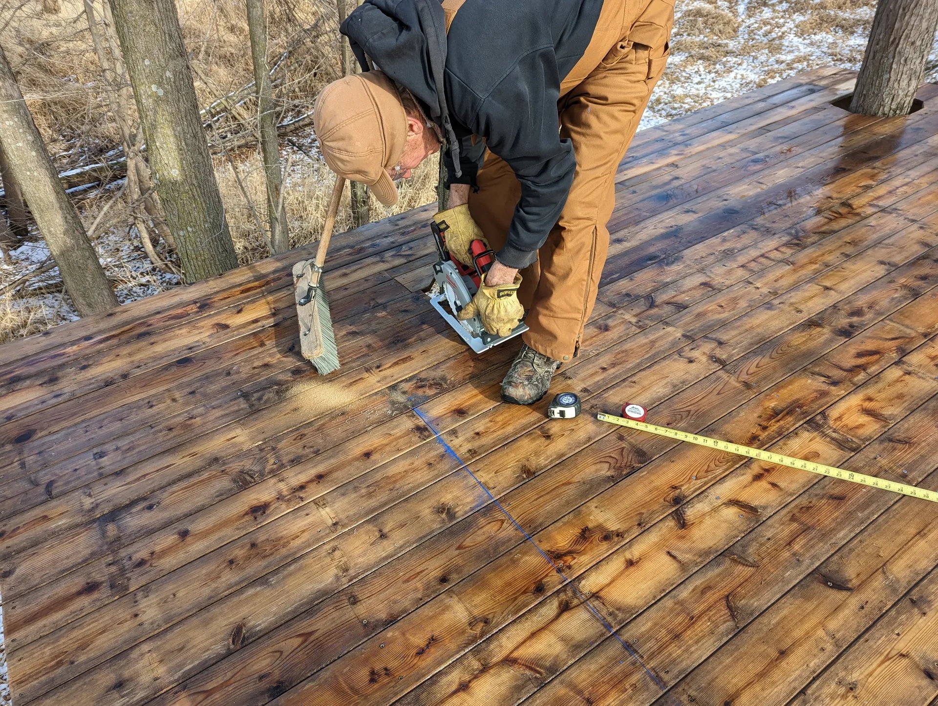 Dad uses a circular saw to cut sections of cedar decking