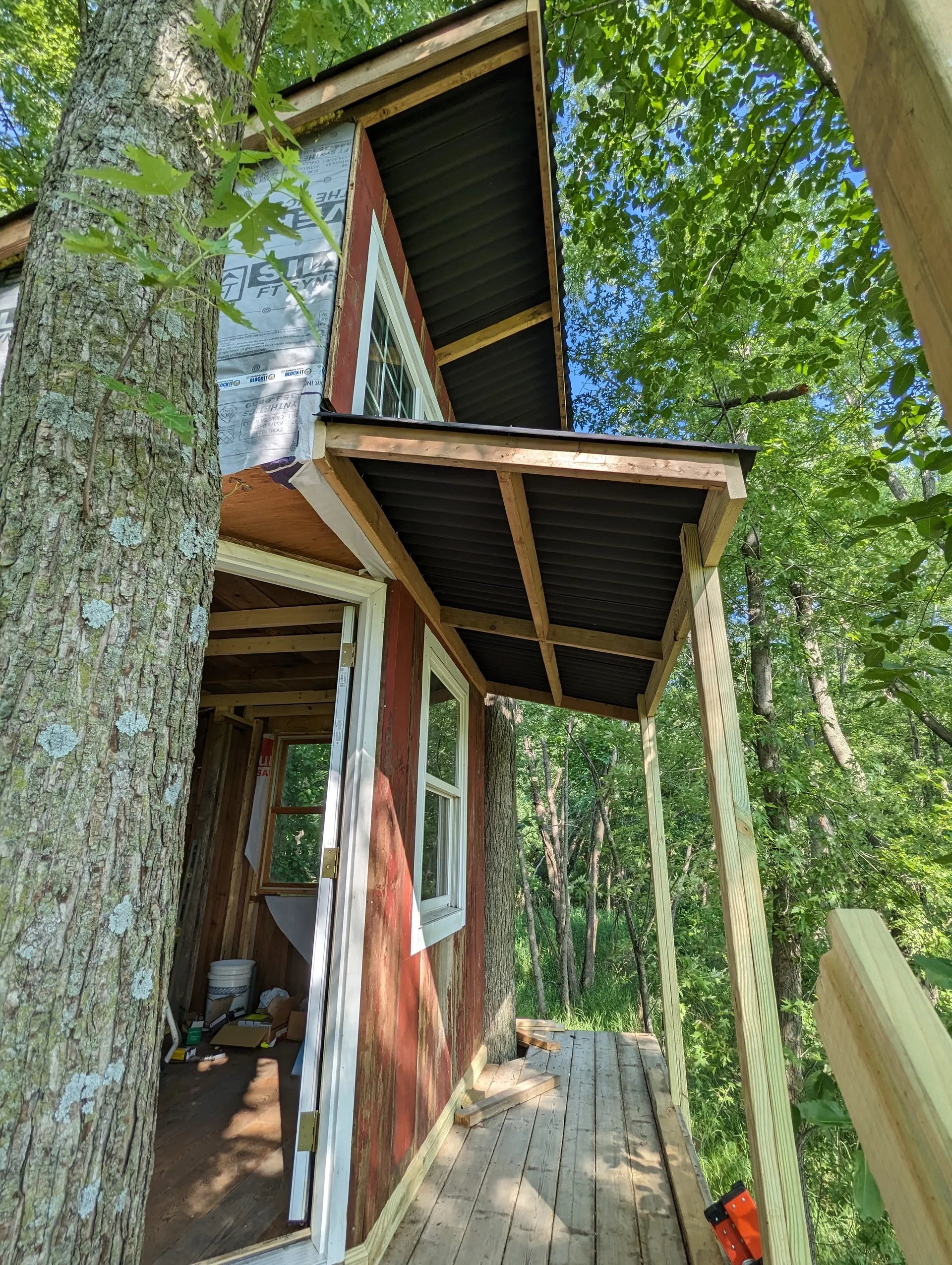 Assembled awning attached with roofing panels