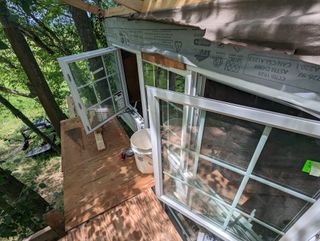 Loft windows installed and open, as seen from the scaffolding