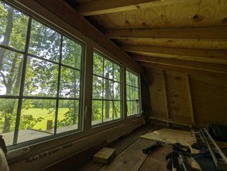 A view from inside the loft, looking through the newly installed triple-windows